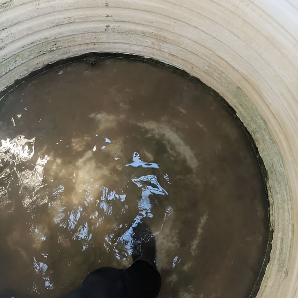 murky, dirty brown water sediment layering at the bottom of a water tank leading to water tank clogging.