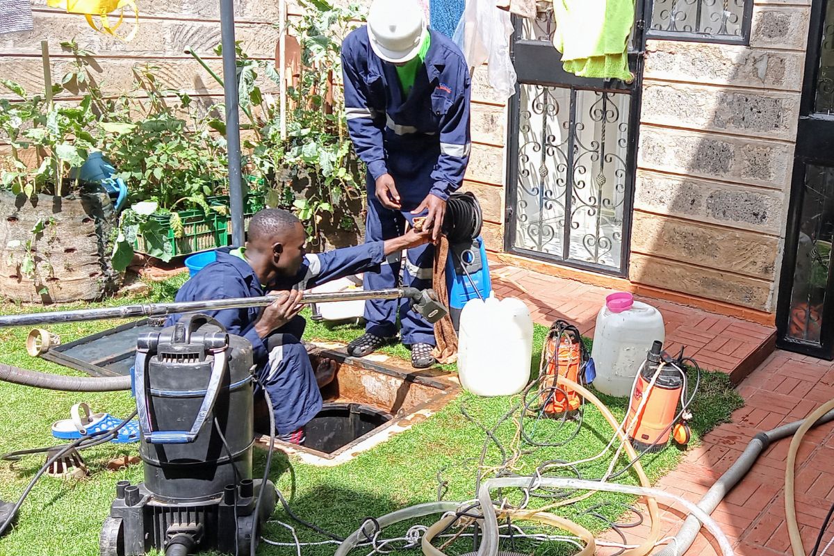 Professional tank cleaners preparing to perform underground water tank cleaning service Nairobi with high-pressure jet.