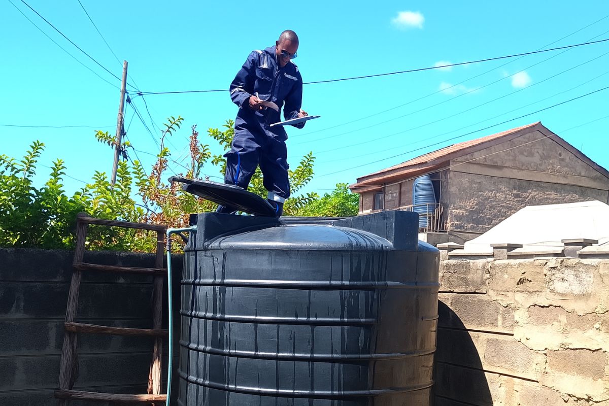 A technician inspecting and cleaning as part of a professional water tank maintenance service to ensure water safety.
